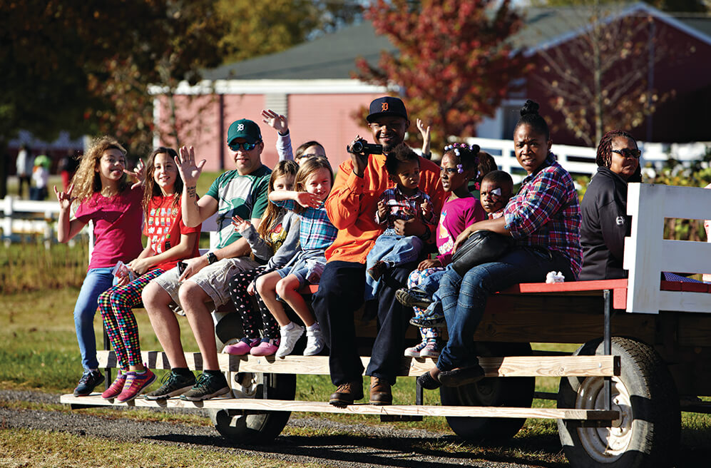 Visitors enjoying a classic wagon ride through Plymouth Orchards.